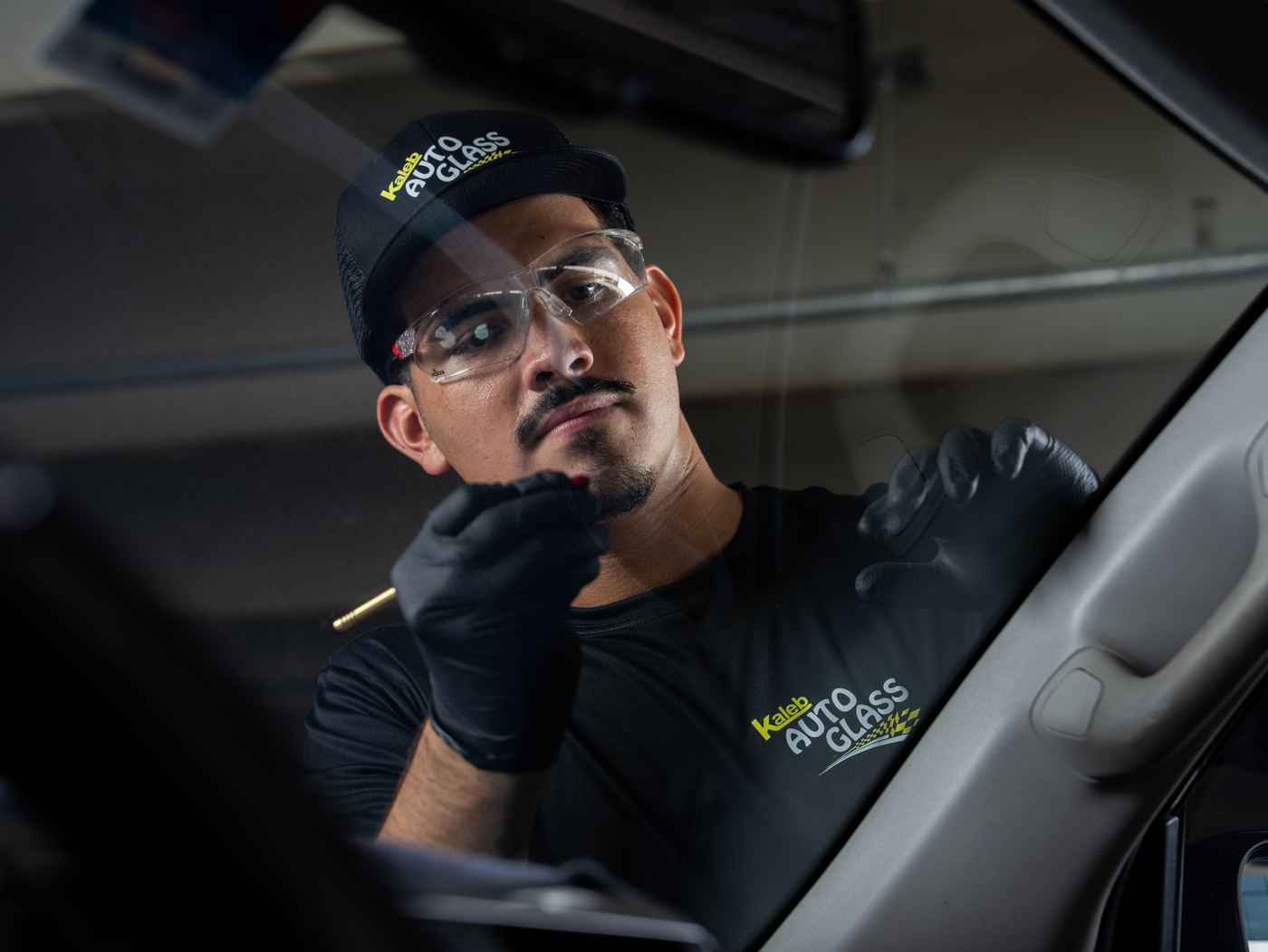 KAG technician focused on a windshield repair