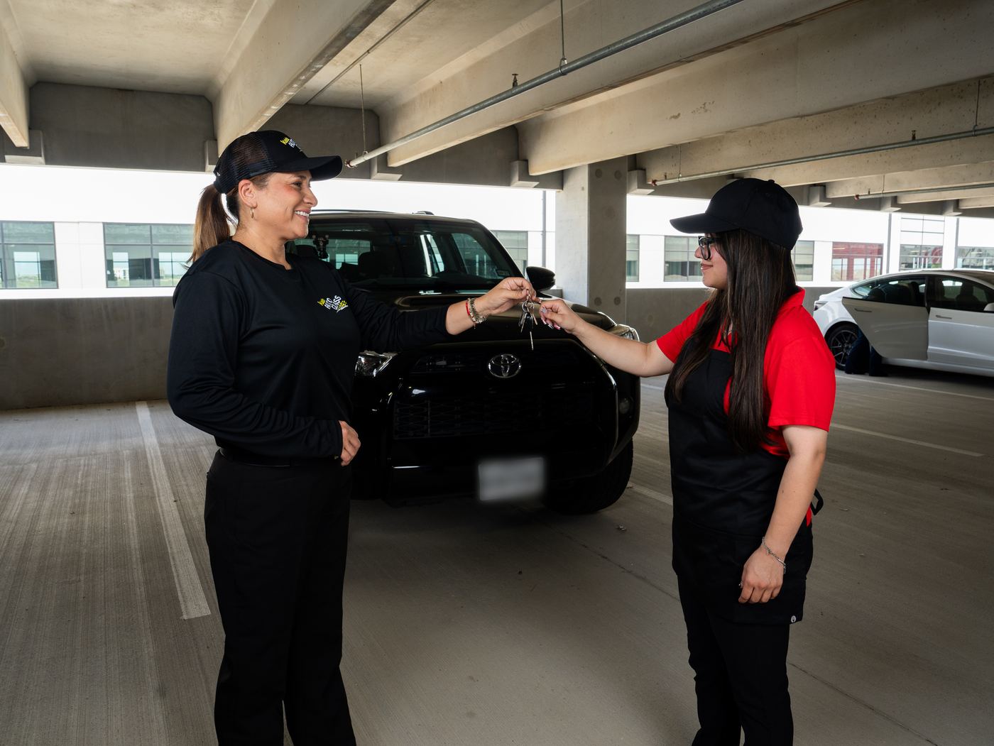 A Kaleb Auto Glass team member handing keys back to a customer