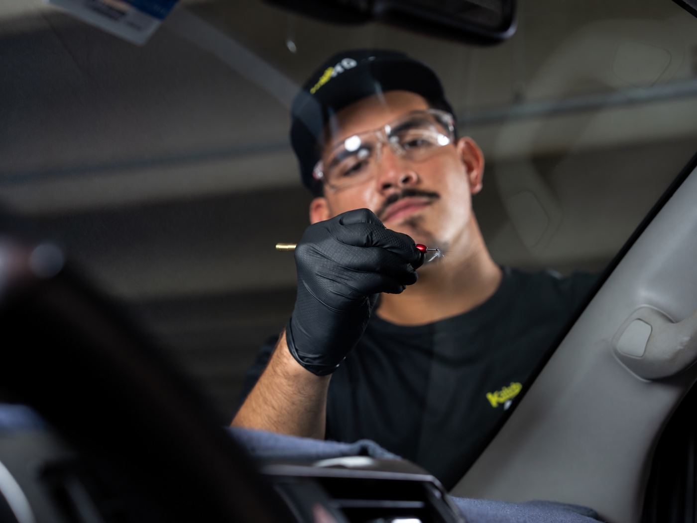 KAG technician repairing a windshield chip